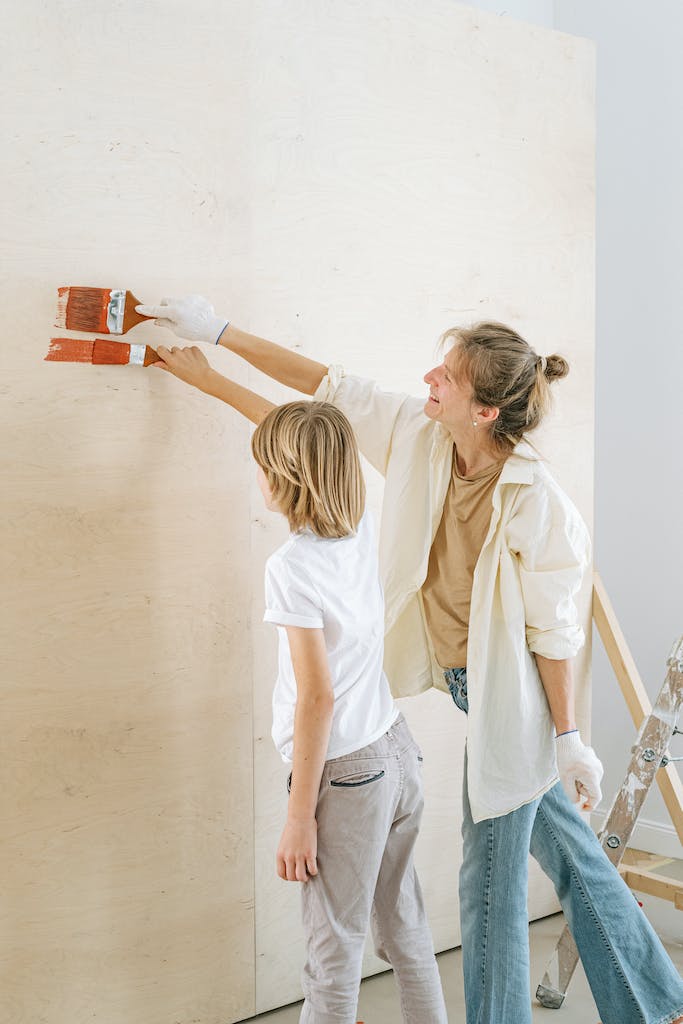 A Mother and Son Painting a Wall